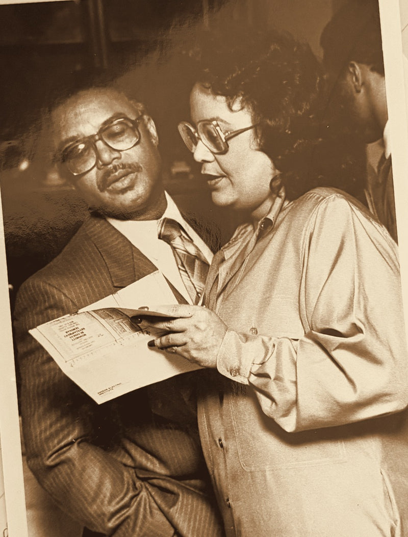 Lou Lampley reviewing a program with a colleague