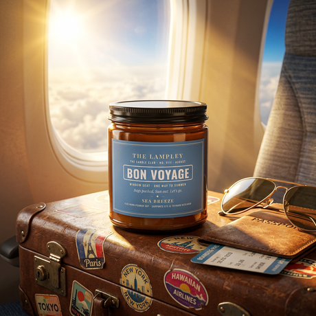 Bon Voyage candle on a vintage suitcase by an airplane window