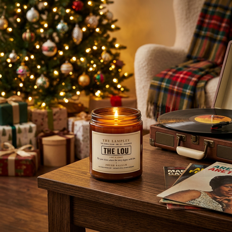 The Lou candle beside a Christmas tree and a record player
