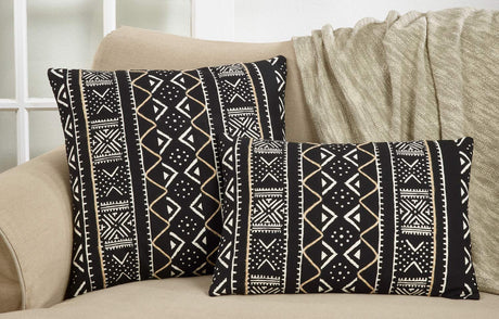 Tribal mud cloth pillow covers on a cream sofa with a throw