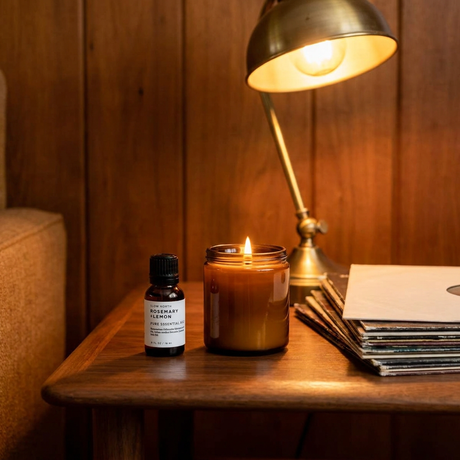 Essential oil diffuser blend beside a candle in a vintage den